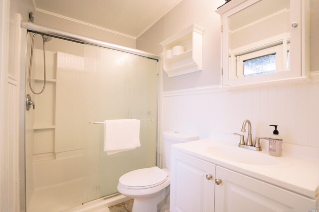 full bath with a shower stall, a wainscoted wall, toilet, vanity, and crown molding