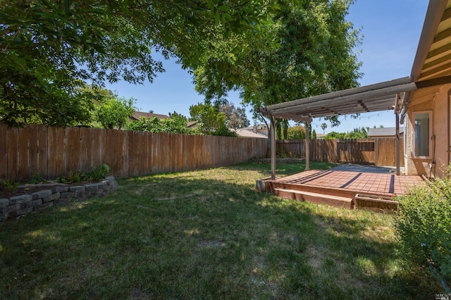 view of yard featuring a fenced backyard and a wooden deck