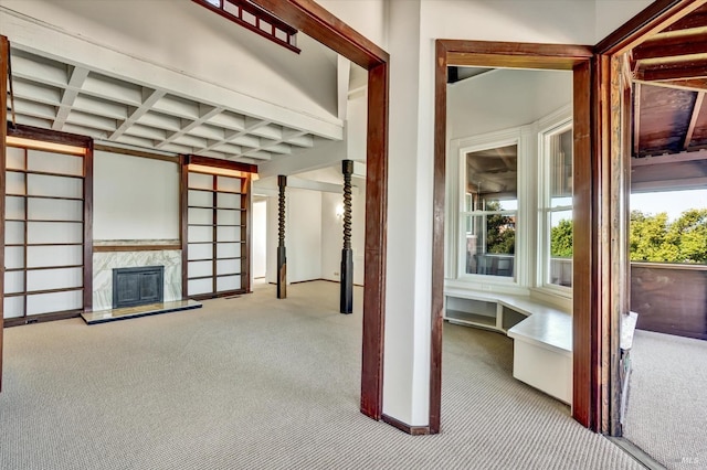 interior space featuring beamed ceiling, carpet, and coffered ceiling