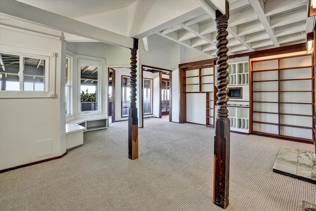 interior space featuring carpet floors, coffered ceiling, and beam ceiling