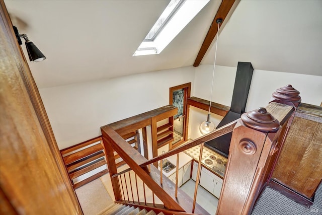 stairway with lofted ceiling with skylight