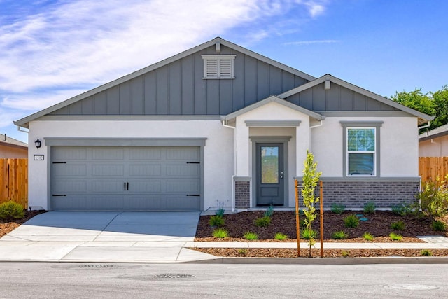 view of front facade featuring concrete driveway, stucco siding, fence, an attached garage, and board and batten siding
