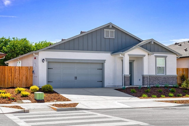 view of front of home with fence, a garage, stucco siding, brick siding, and driveway