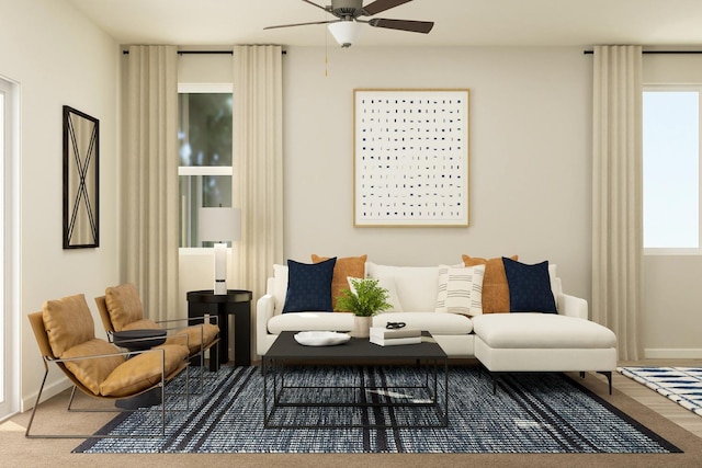 living area featuring baseboards and ceiling fan