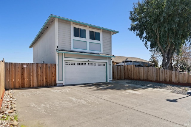 view of home's exterior with a garage, concrete driveway, and fence