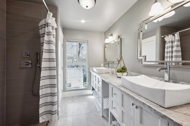 3292 Holland Dr, Santa Rosa, CA 95404 - full bathroom featuring a sink, tiled shower, marble finish floor, and double vanity
