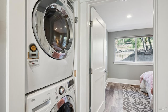 3292 Holland Dr, Santa Rosa, CA 95404 - laundry room featuring laundry area, stacked washer / drying machine, baseboards, and wood finished floors