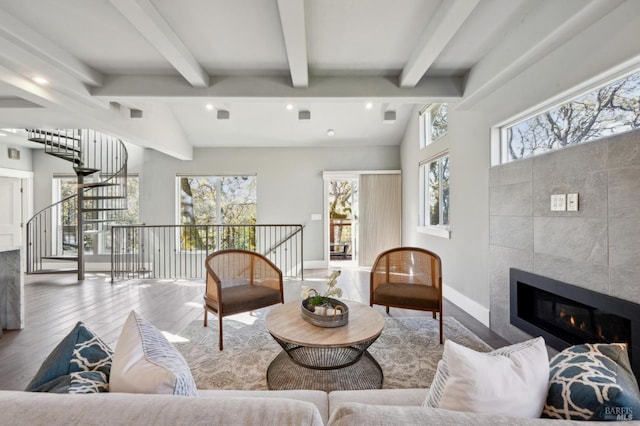3292 Holland Dr, Santa Rosa, CA 95404 - living room featuring a wealth of natural light, wood finished floors, vaulted ceiling with beams, and a tile fireplace