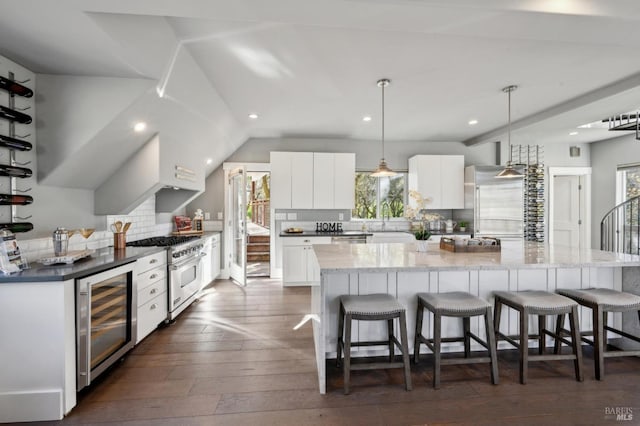 3292 Holland Dr, Santa Rosa, CA 95404 - kitchen featuring a spacious island, wine cooler, high quality appliances, a kitchen bar, and dark wood-style floors