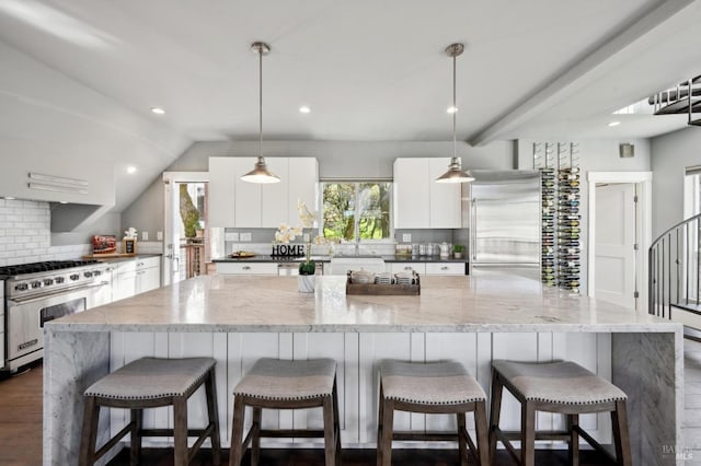 3292 Holland Dr, Santa Rosa, CA 95404 - kitchen featuring dark wood-style floors, a spacious island, decorative backsplash, white cabinetry, and high quality appliances