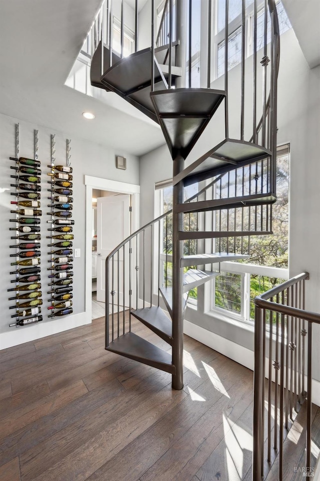 3292 Holland Dr, Santa Rosa, CA 95404 - stairway featuring hardwood / wood-style flooring, recessed lighting, baseboards, and a towering ceiling