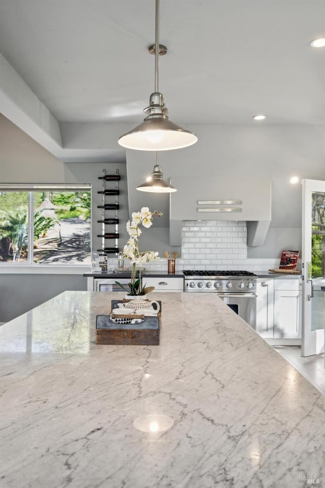 3292 Holland Dr, Santa Rosa, CA 95404 - kitchen with light stone counters, tasteful backsplash, a wealth of natural light, and high end stove