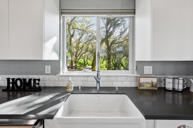 3292 Holland Dr, Santa Rosa, CA 95404 - kitchen with a sink, dark countertops, a healthy amount of sunlight, and white cabinetry