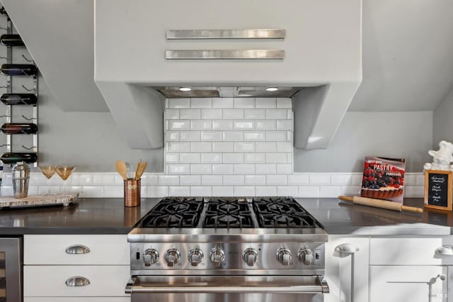 3292 Holland Dr, Santa Rosa, CA 95404 - kitchen featuring tasteful backsplash, dark countertops, beverage cooler, high end stainless steel range oven, and white cabinetry