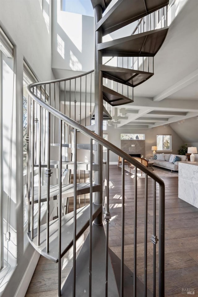 3292 Holland Dr, Santa Rosa, CA 95404 - stairway featuring baseboards, beam ceiling, a high ceiling, and wood finished floors