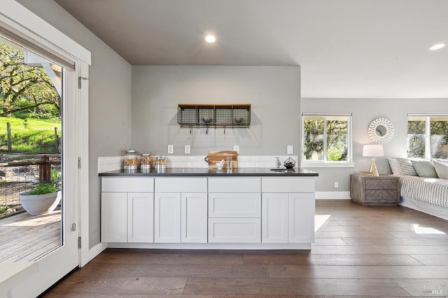 3292 Holland Dr, Santa Rosa, CA 95404 - kitchen featuring dark countertops, dark wood-style floors, open floor plan, and a healthy amount of sunlight