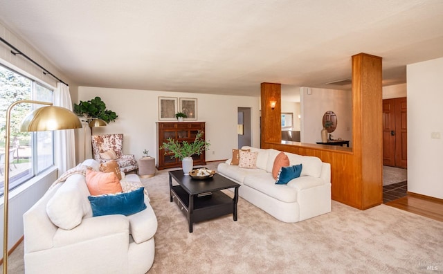 carpeted living room featuring baseboards