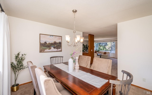 dining area with a notable chandelier, carpet, and baseboards