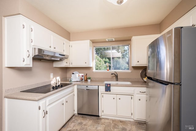 kitchen featuring under cabinet range hood, a sink, stainless steel appliances, white cabinets, and light countertops