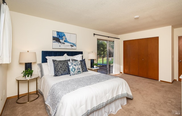 bedroom with baseboards, carpet floors, a textured ceiling, and a closet