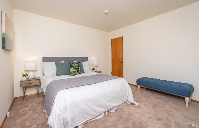 bedroom featuring baseboards and carpet