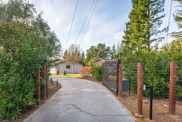 exterior space featuring aphalt driveway, a gate, and a gated entry