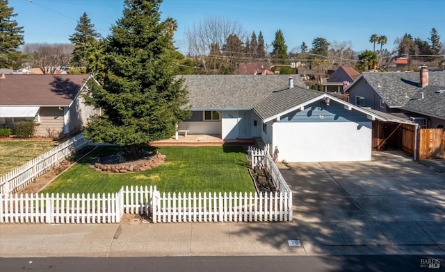 ranch-style house featuring a fenced front yard, driveway, a front lawn, and a garage