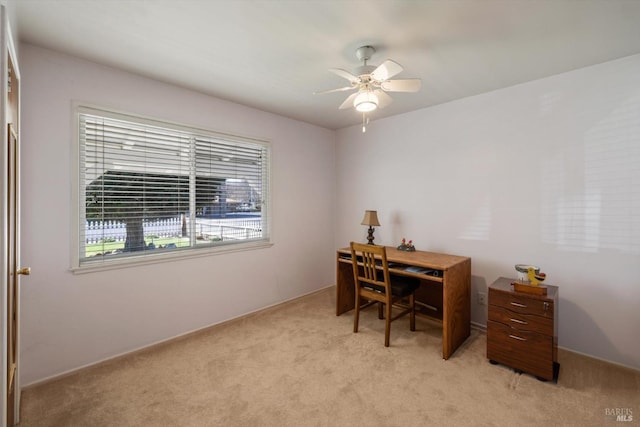 office space with ceiling fan and light carpet