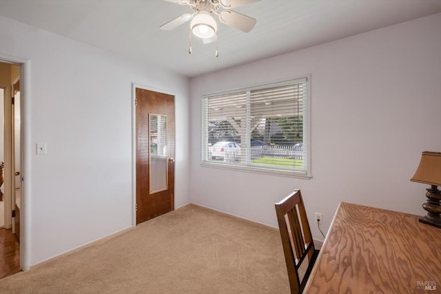 unfurnished office featuring light colored carpet and ceiling fan