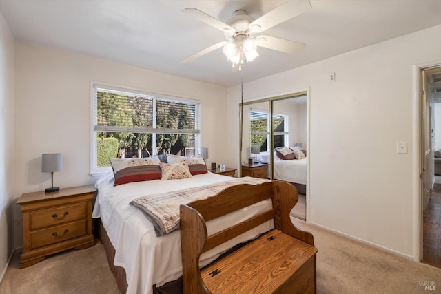 bedroom featuring a closet, light carpet, and a ceiling fan
