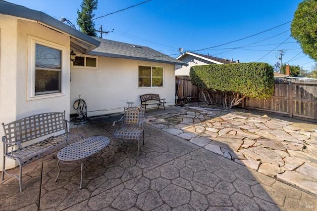 view of patio / terrace featuring fence