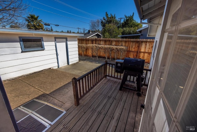 deck featuring a patio, area for grilling, and fence