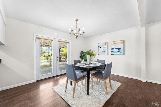 dining space featuring visible vents, dark wood-type flooring, baseboards, french doors, and a notable chandelier