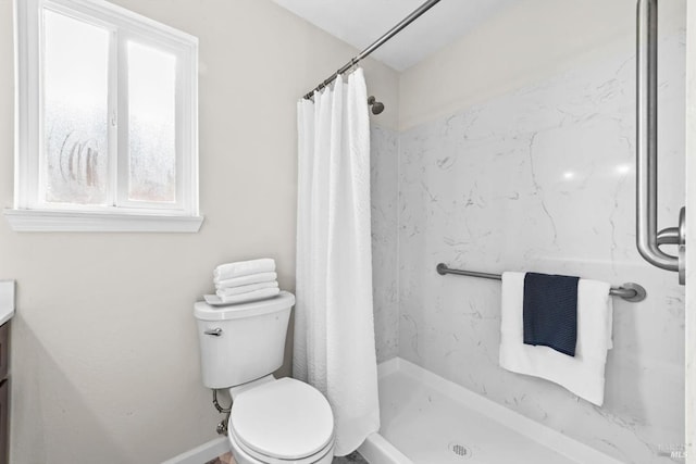 bathroom with vanity, toilet, and a stall shower