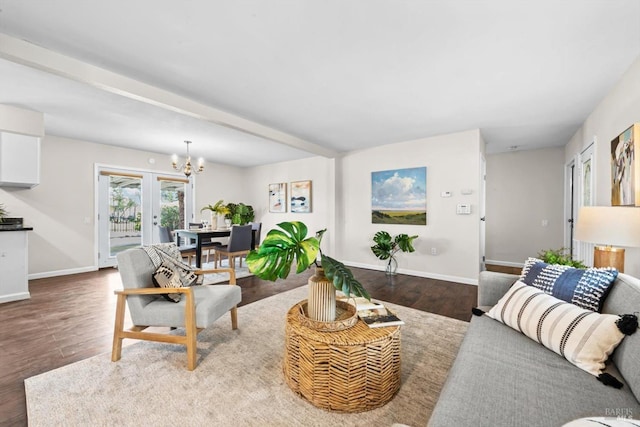 living area featuring baseboards, an inviting chandelier, and wood finished floors