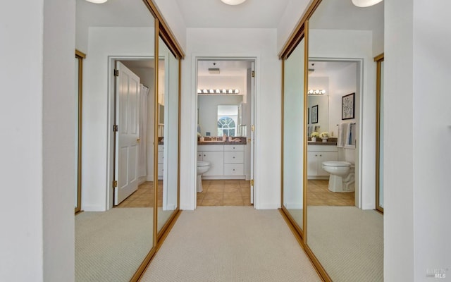 hallway with tile patterned floors and carpet floors