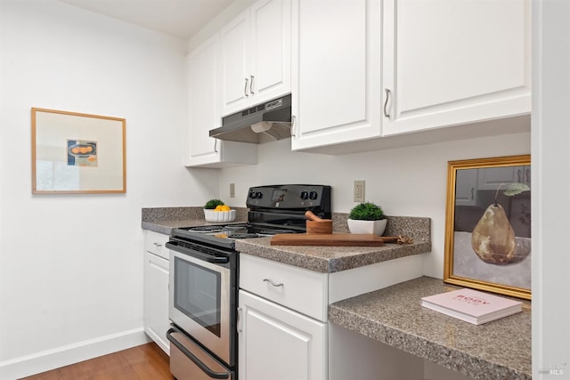 kitchen featuring baseboards, light wood finished floors, white cabinets, electric stove, and under cabinet range hood