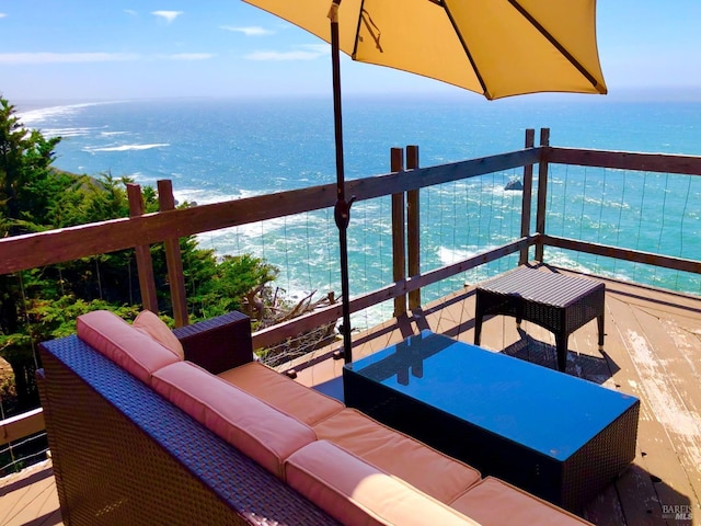 balcony with a water view and an outdoor hangout area