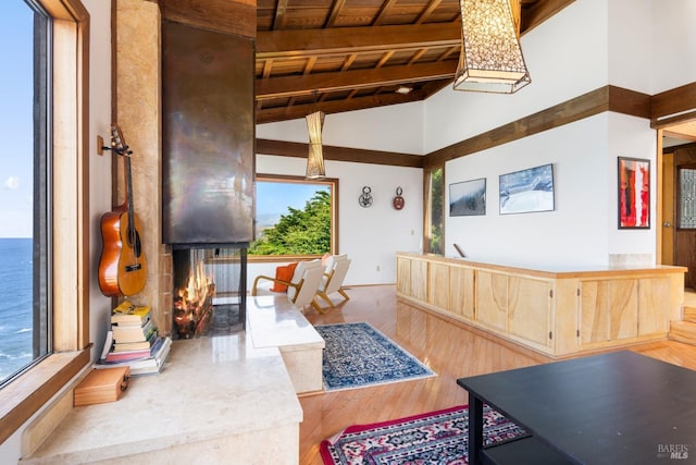 living room with high vaulted ceiling, beamed ceiling, wood ceiling, and wood finished floors