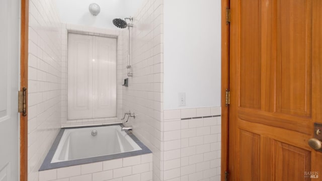 bathroom featuring tile walls and tiled shower / bath