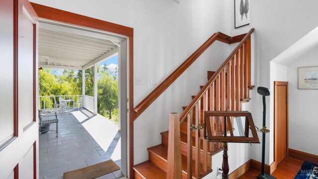 staircase featuring baseboards