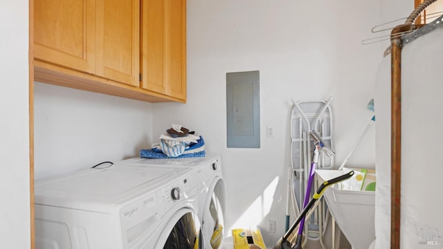 laundry area with washer and dryer, cabinet space, and electric panel