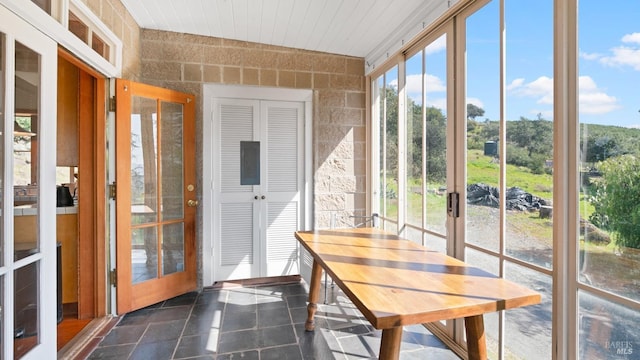 sunroom featuring a wealth of natural light and outdoor dining area