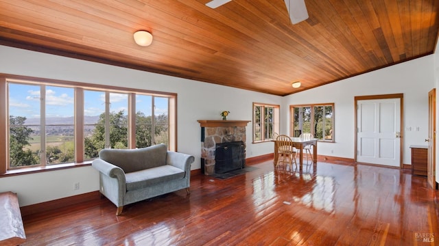 living room with vaulted ceiling, wooden ceiling, wood-type flooring, baseboards, and ceiling fan