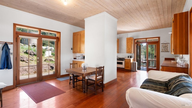 interior space with wood finished floors, plenty of natural light, french doors, and wooden ceiling