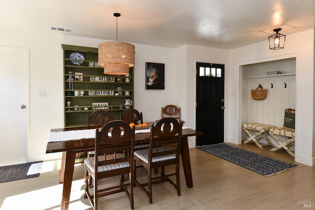 dining area featuring visible vents and light wood finished floors