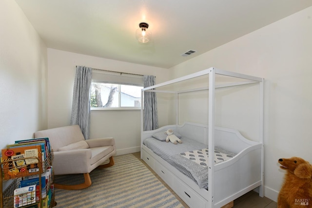 carpeted bedroom with visible vents and baseboards