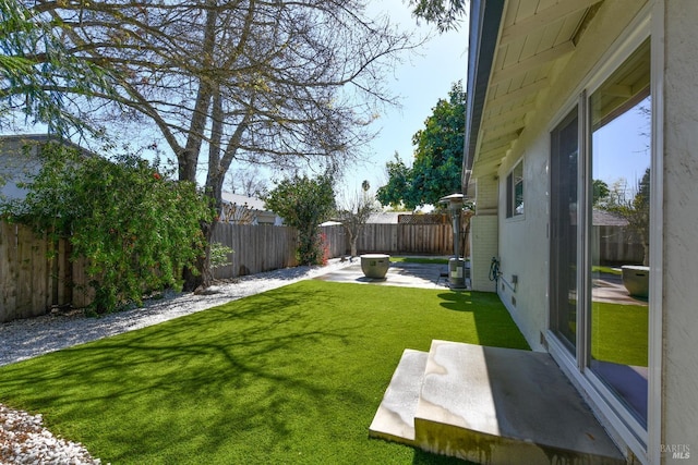 view of yard with a patio and a fenced backyard