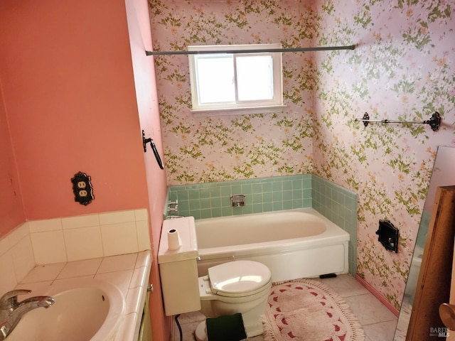 bathroom with a bathtub, toilet, tile patterned floors, and wallpapered walls