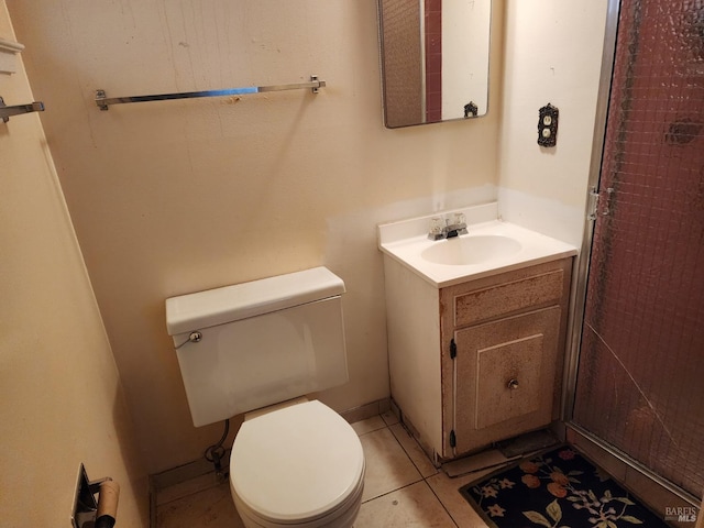 bathroom featuring vanity, tile patterned floors, and toilet